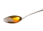 A spoon of honey over white background - The Alternative Daily