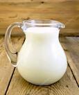 Milk in glass jug on board Stock Photo by ©rezkrr 61837331