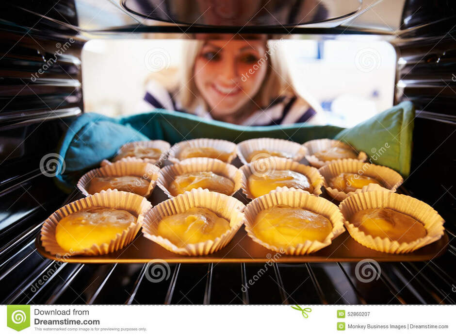 Woman Putting Cupcakes into Oven To Bake Stock Image - Image of person, cupcake: 52860207